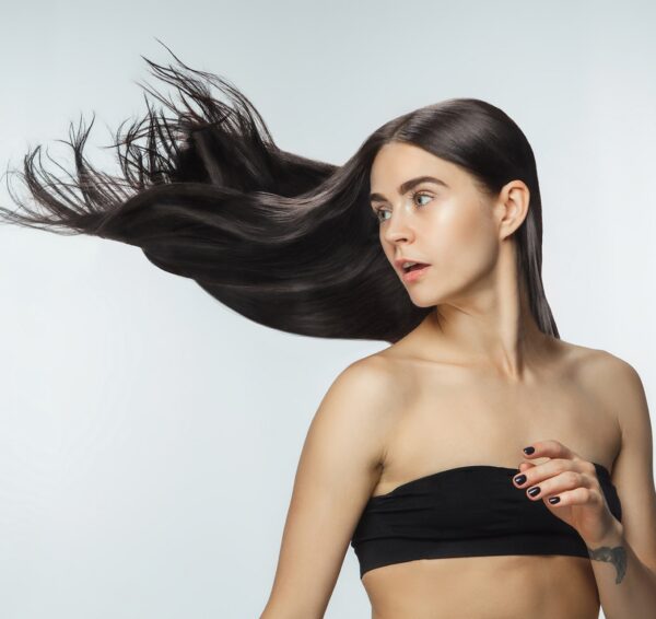 beautiful-model-with-long-smooth-flying-brunette-hair-isolated-white-studio-background